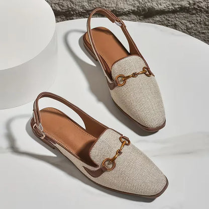 Flat sandal with metallic buckle fastening