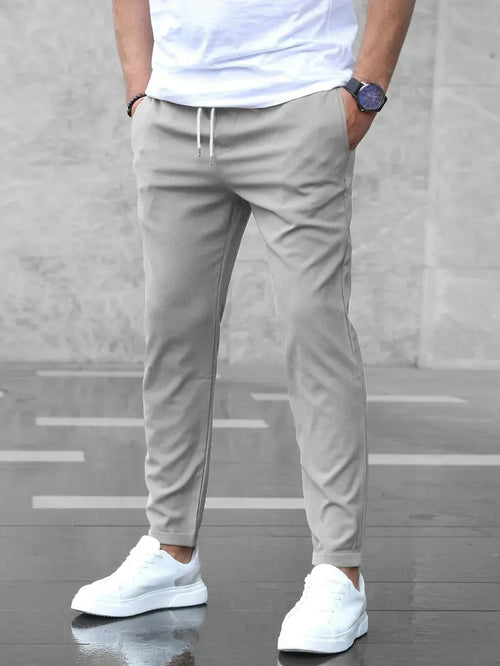 Slim fit trousers with elastic waistband and side pockets
