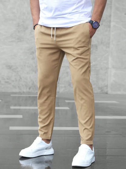 Slim fit trousers with elastic waistband and side pockets