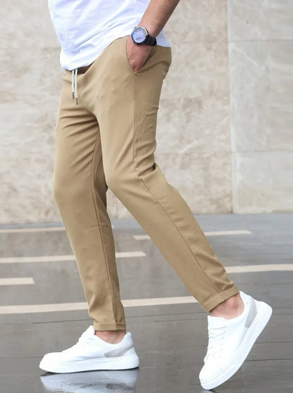 Slim fit trousers with elastic waistband and side pockets