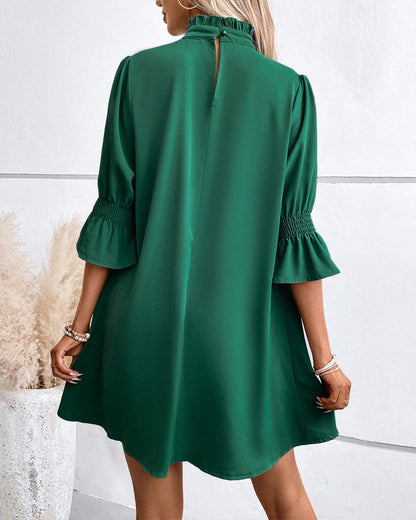 Elegant dress with a high collar in a solid colour