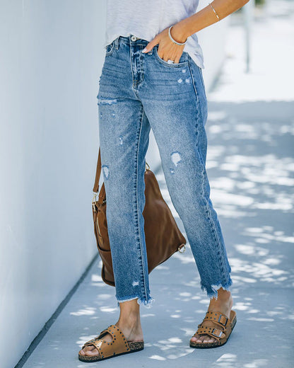 Slim straight jeans with rips in the legs